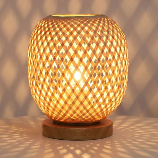 Handwoven bamboo table lamp creating a cozy, warm ambiance with a natural design, perfect for bedside or living room lighting.