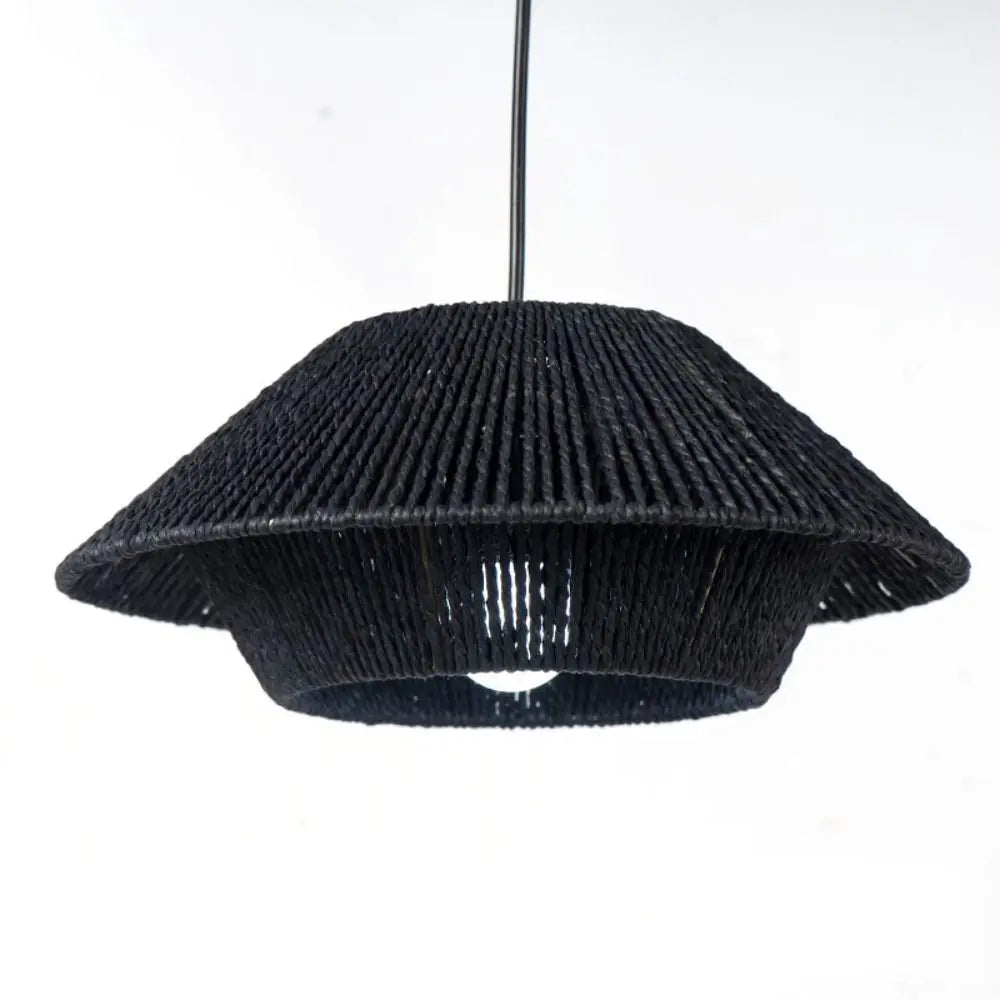 Close-up of handwoven rattan pendant light shades in black and beige, showcasing intricate craftsmanship and boho design.