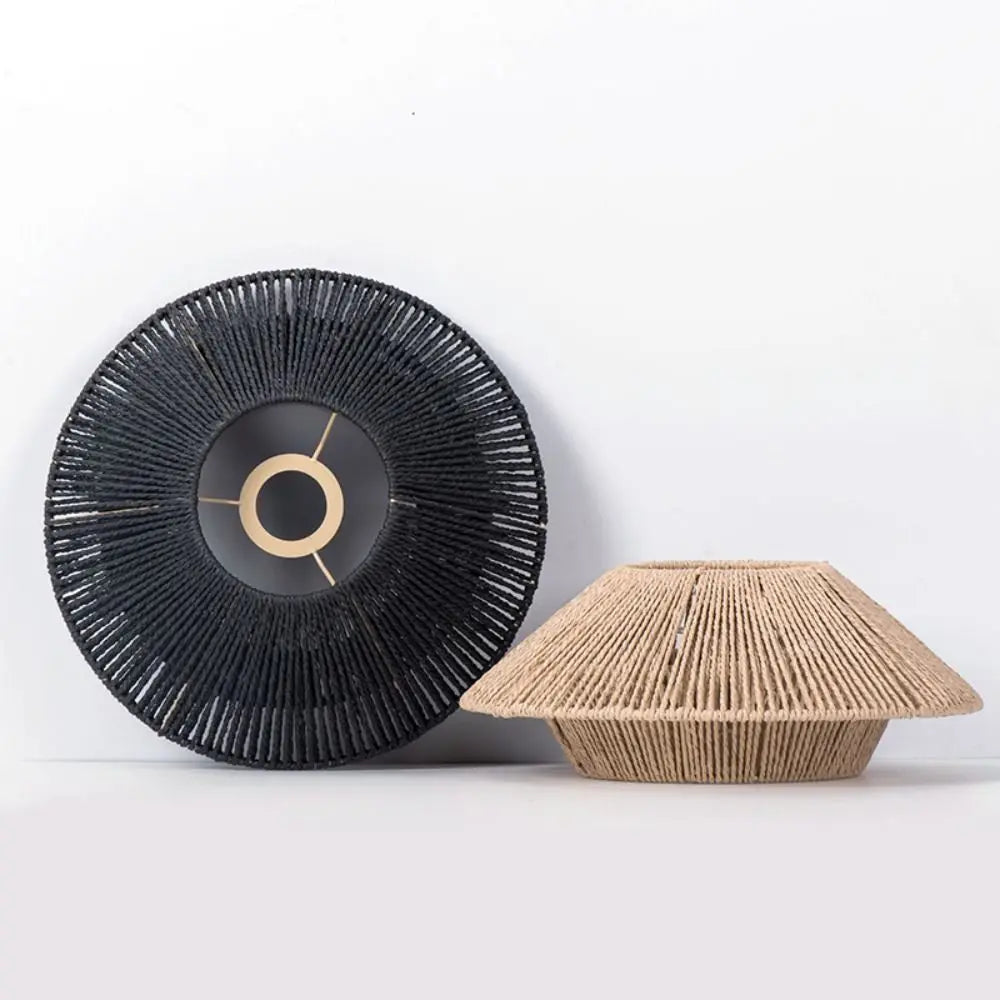 Close-up of handwoven rattan pendant light shades in black and beige, showcasing intricate craftsmanship and boho design.